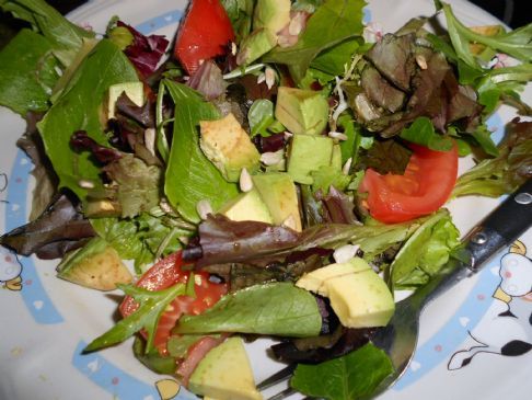 Mixed greens with avocado, nuts and raisins