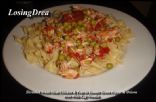 Shreaded Chicken In Tomatoes With Peas Over Wide Egg Noodles